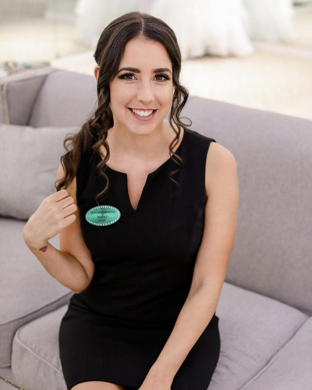Nicole Sonmez smiling, in a black sleeveless dress